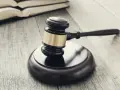 Młotek sędziowski i księgi na drewnianym stole. Sprawa o przedawnienie oszustwo może być trudna do udowodnienia.