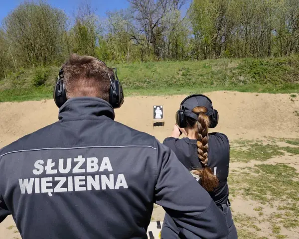 Na strzelnicy Służby Więziennej, funkcjonariuszka ćwiczy celność. To nie jest zwykłe pdw slang, to profesjonalne szkolenie.